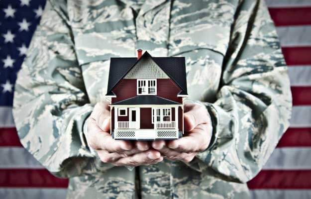 Veteran holding a house